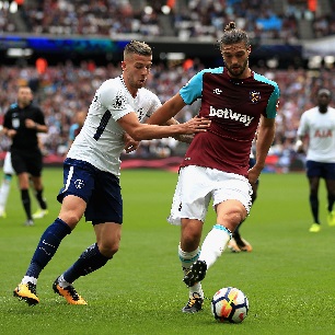 Andy Carroll takes on Tottenham Hotspur's Toby Alderweireld