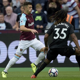 Aaron Cresswell takes on Swansea City's Renato Sanches