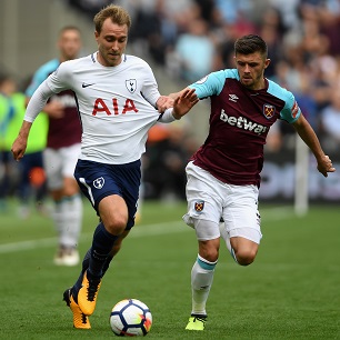 Aaron Cresswell challenges Tottenham Hotspur's Christian Eriksen