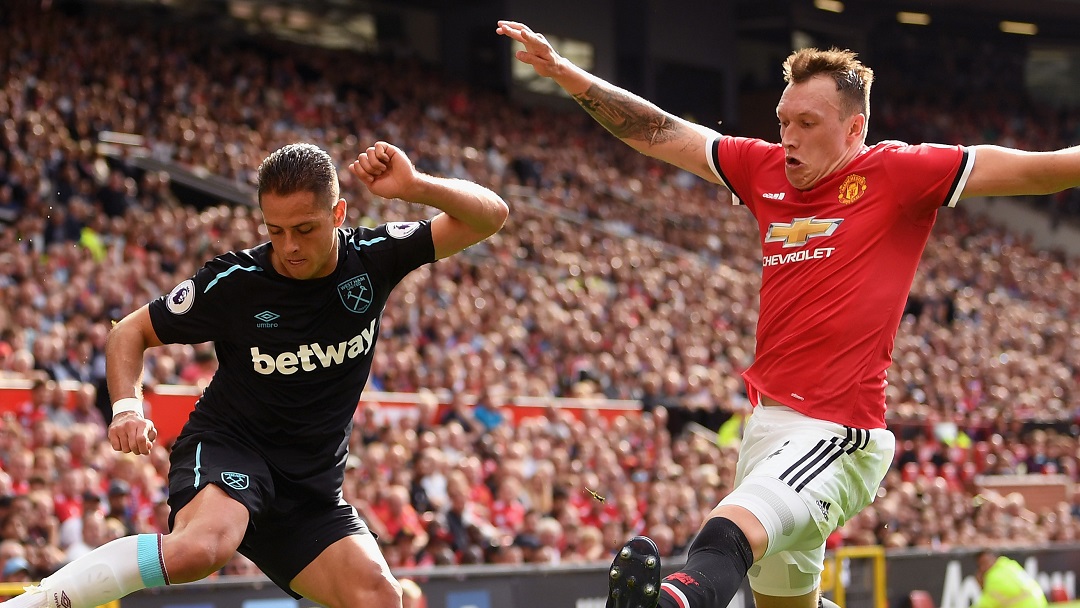 Chicharito and Manchester United's Phil Jones contest possession