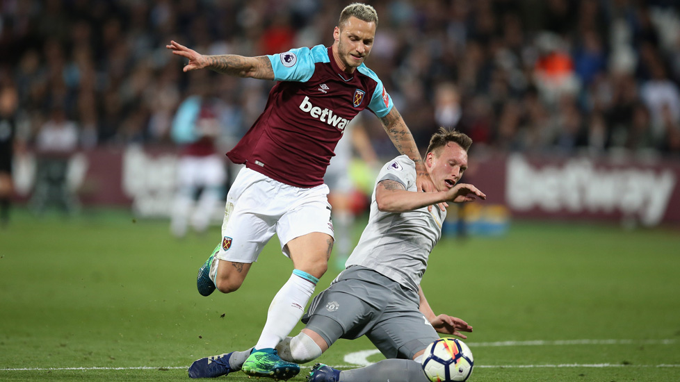 Marko Arnautovic runs past Phil Jones