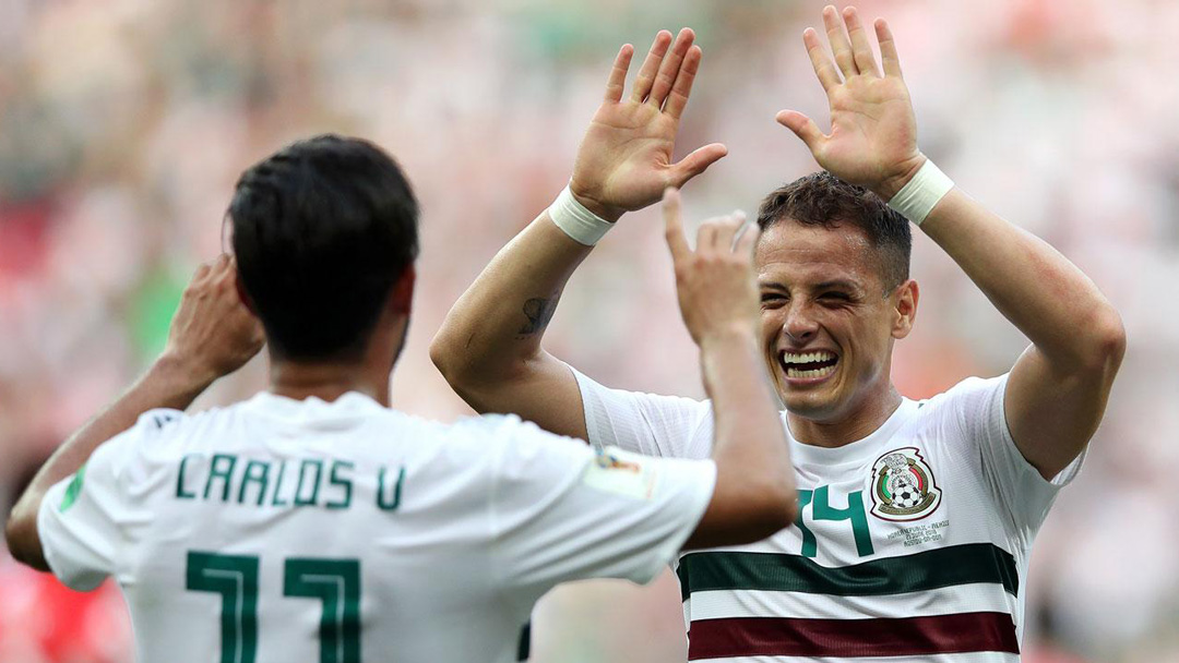 Chicharito celebrates Mexico's win over South Korea with Carlos Vela