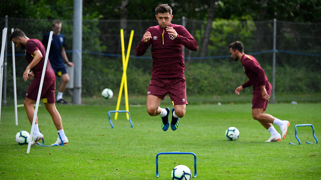 Aaron Cresswell jumps during pre-season training in Switzerland