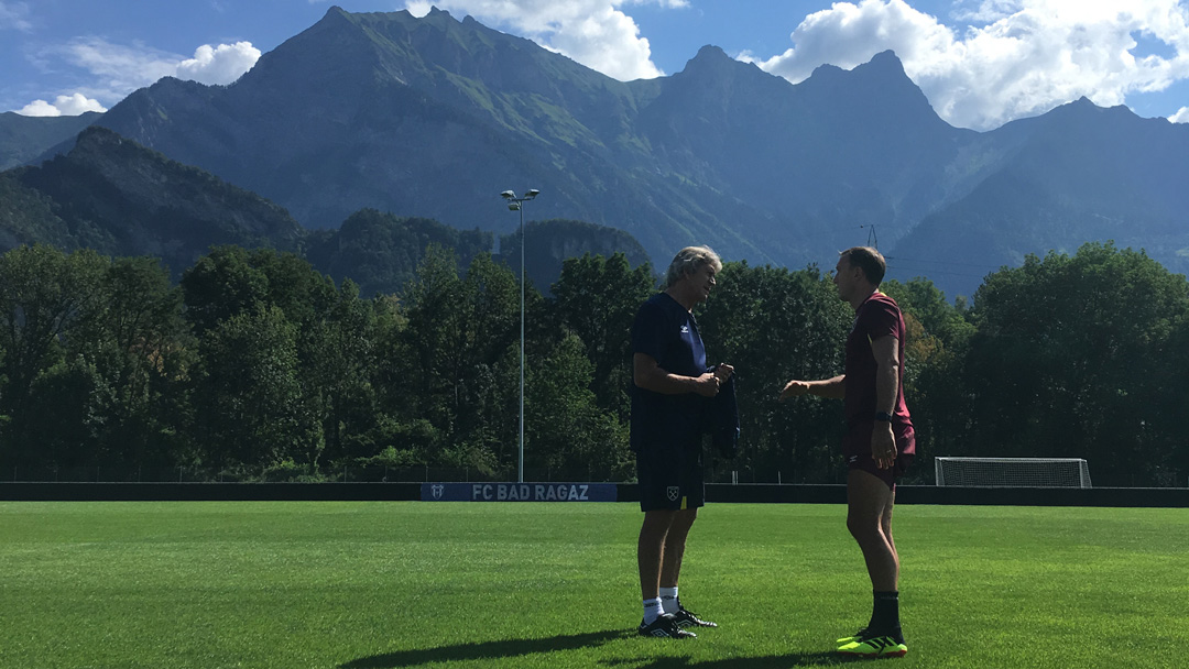 Mark Noble and Manuel Pellegrini chat on the training pitch in Bad Ragaz