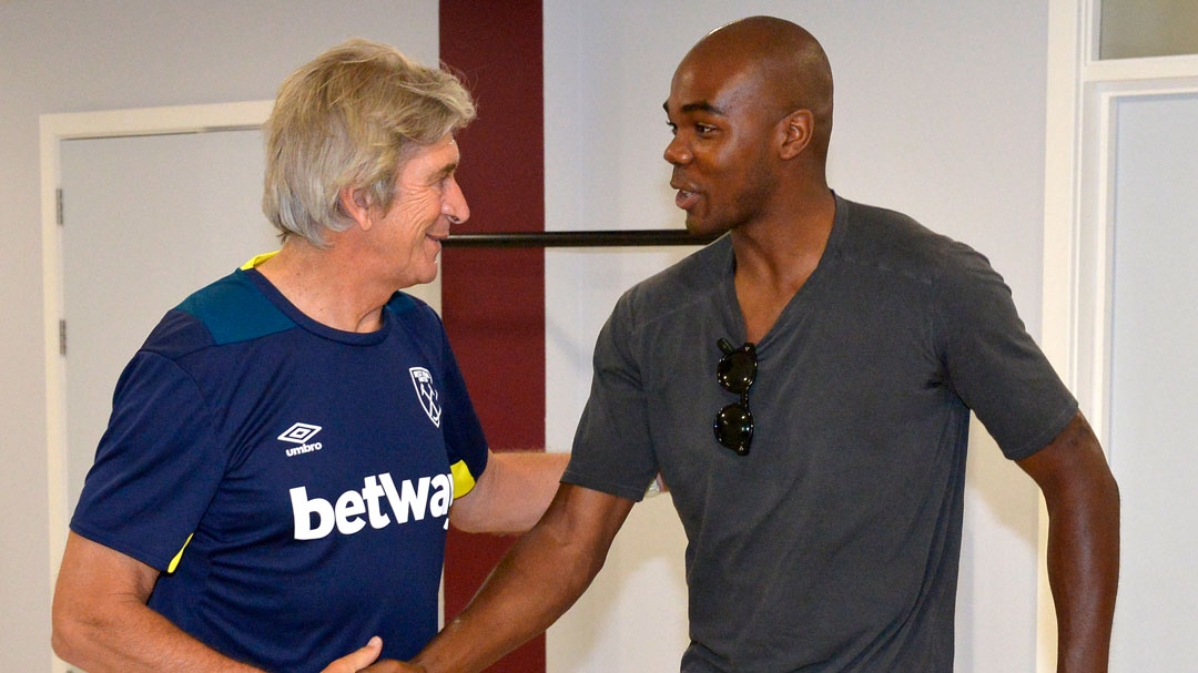 Manuel Pellegrini greets Angelo Ogbonna