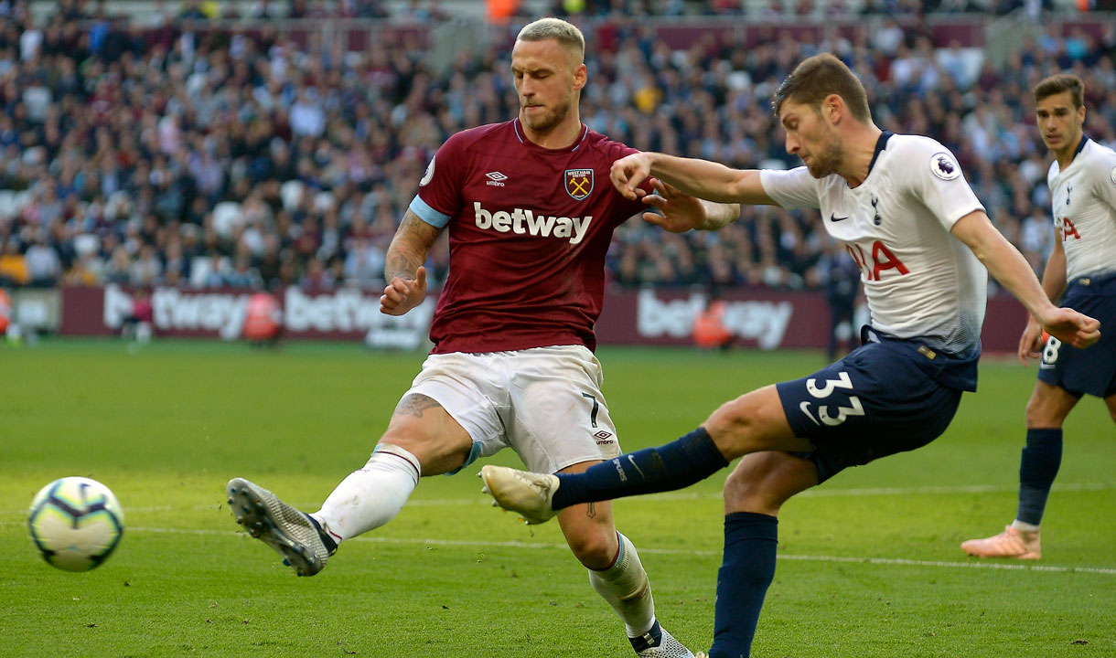 Marko Arnautovic attempts to block Ben Davies' pass