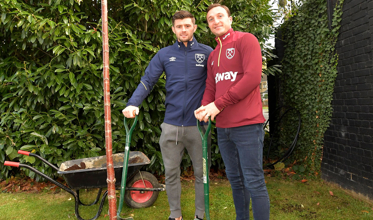 Aaron Cresswell and Mark Noble plant a tree for Football Remembers