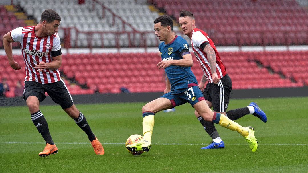 Nathan Holland takes on the Brentford defence