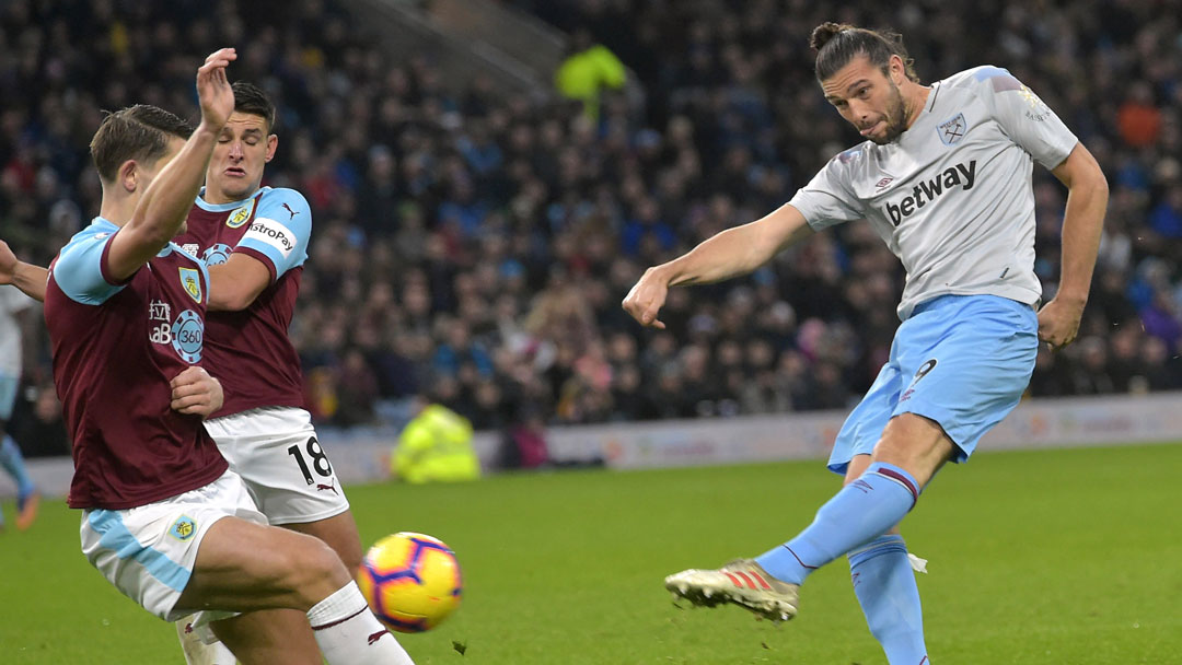 Andy Carroll sees a shot blocked by the Burnley defence