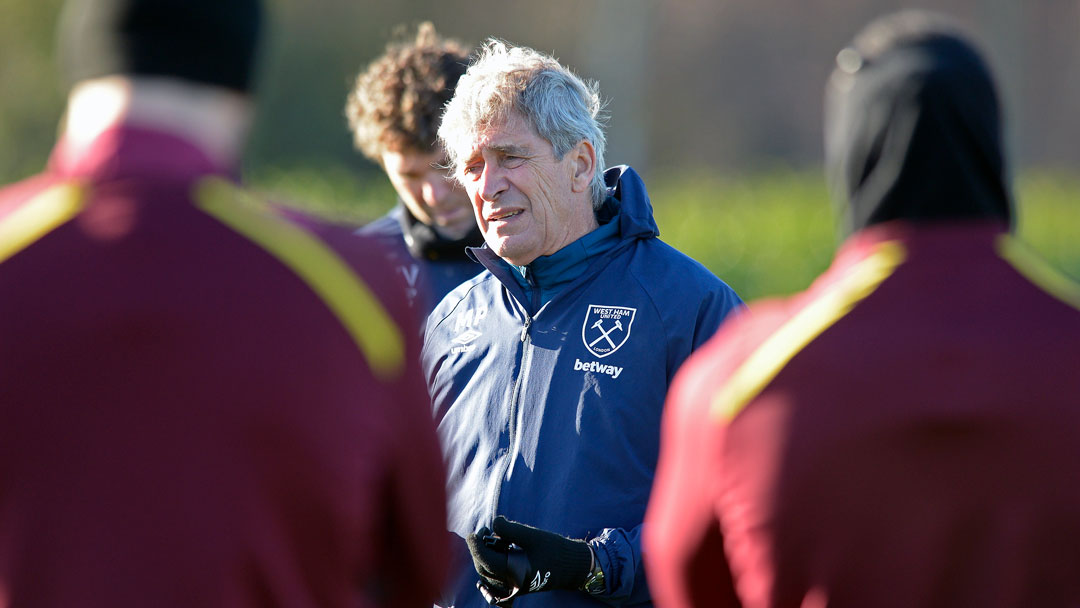 Manuel Pellegrini talks to his players at Rush Green