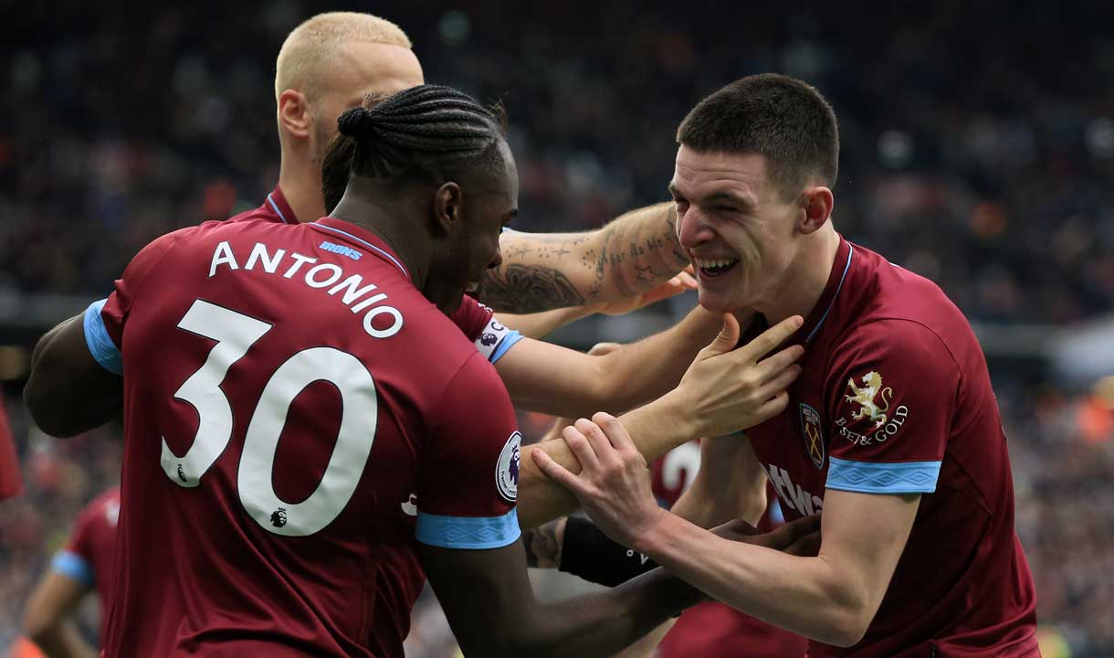 West Ham players celebrate the winning goal against Arsenal
