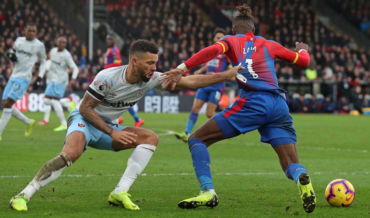 Ryan Frederick battles with Wilfried Zaha