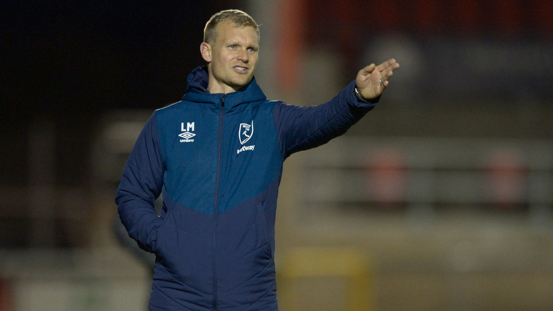 Liam Manning makes his point during the defeat by Liverpool