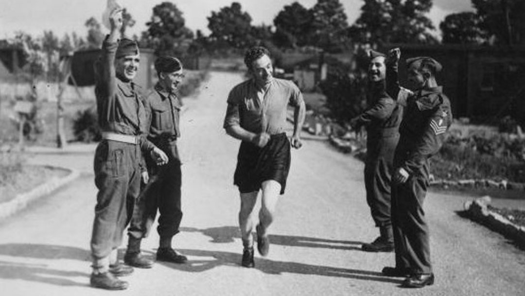 Harry Medhurst laces his football boots while at his Army barracks