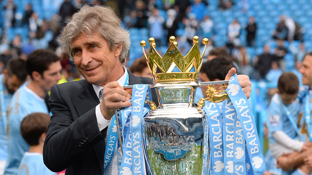 Manuel Pellegrini holds the Premier League trophy aloft