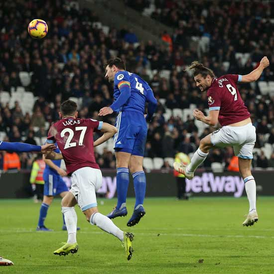 Andy Carroll heads for goal against Cardiff
