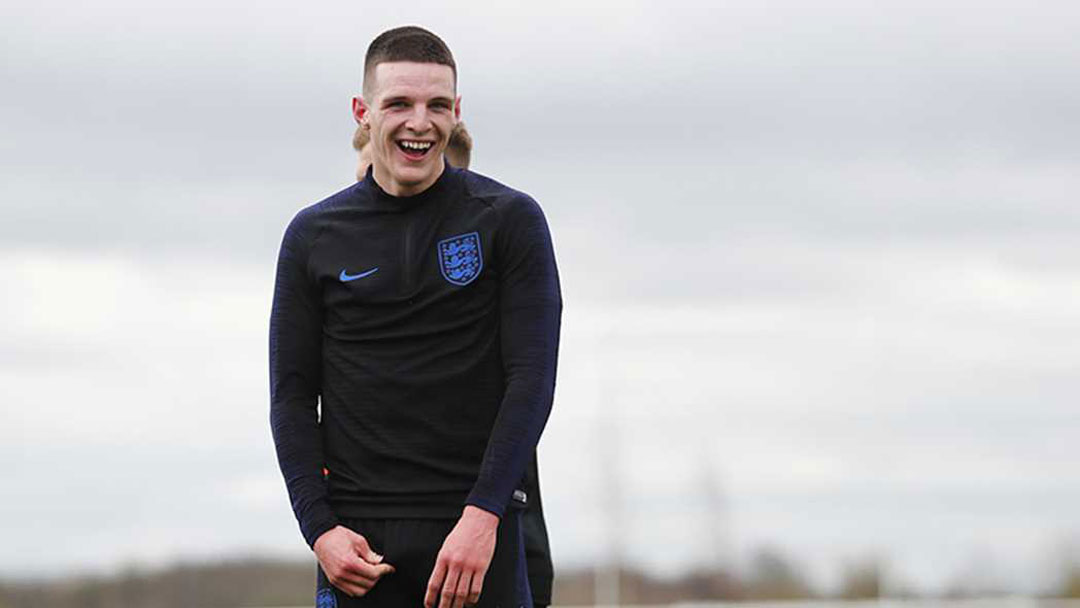 Declan Rice laughs during England training