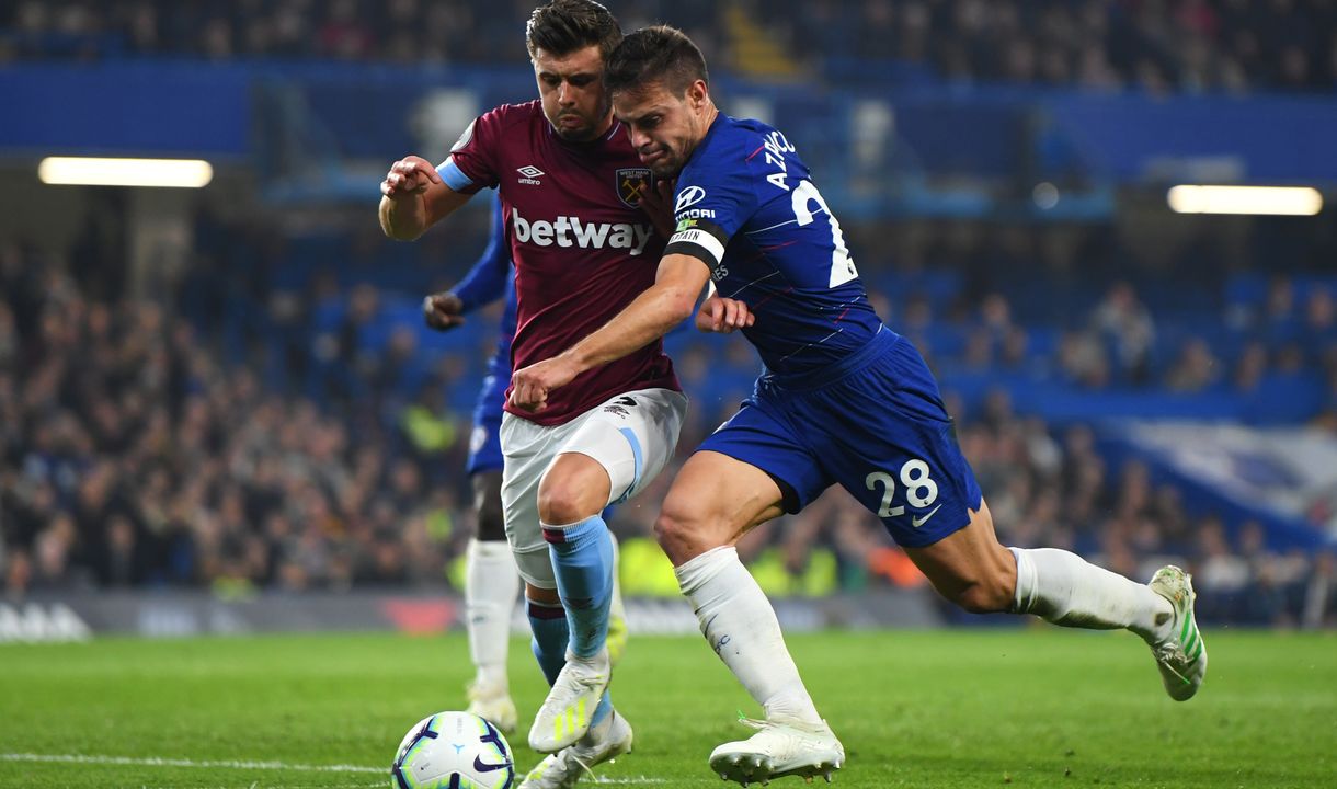 Aaron Cresswell challenges Cesar Azpilicueta