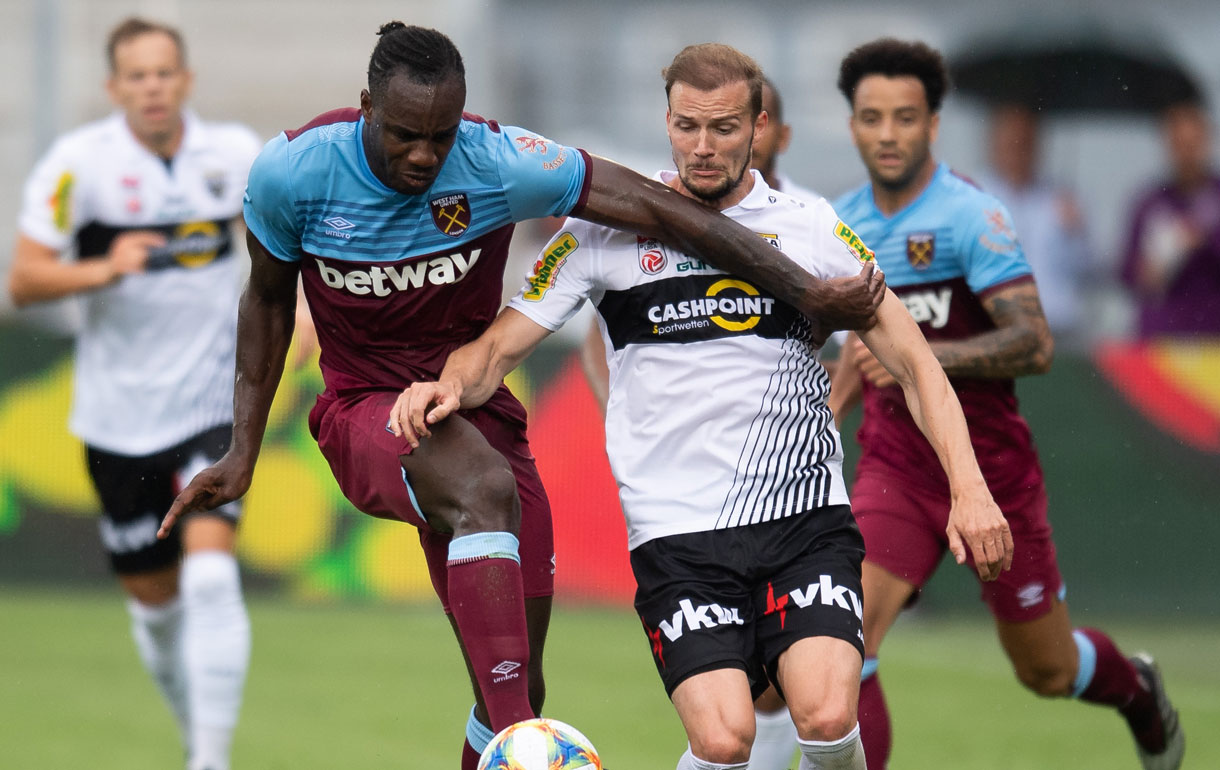 Michail Antonio battles for possession