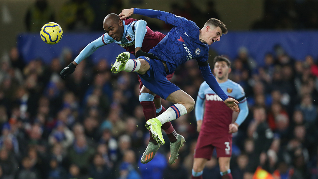 Angelo Ogbonna tussles for possession at Stamford Bridge