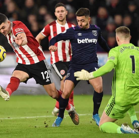 Manuel Lanzini battles for the ball