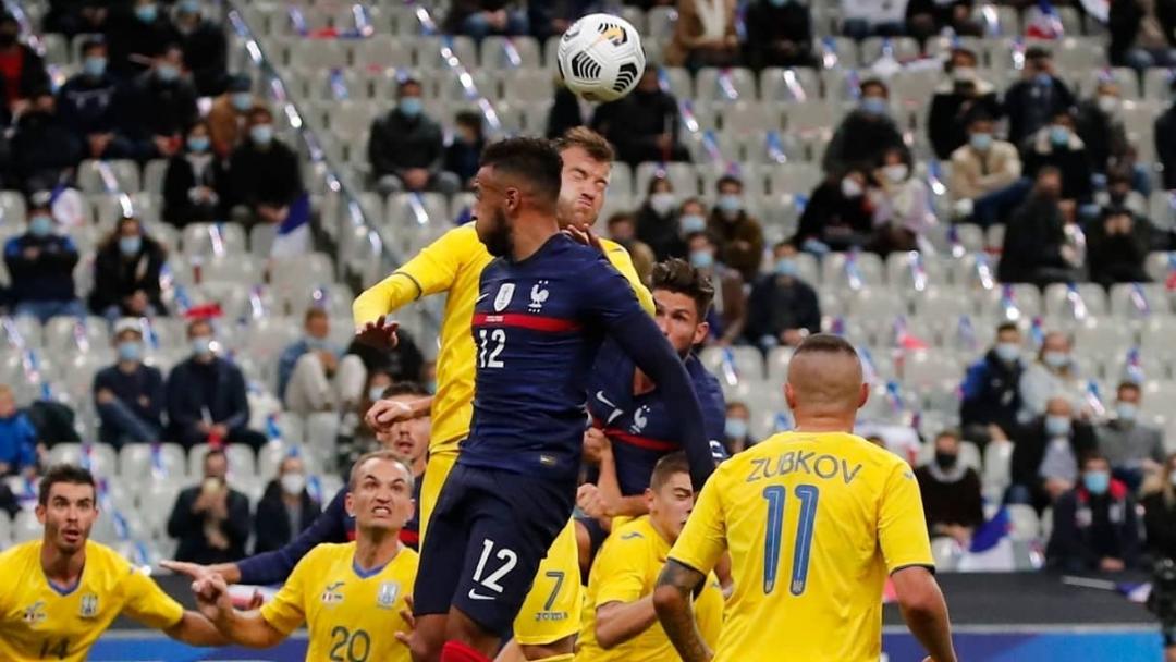 Andriy Yarmolenko goes for a header against France