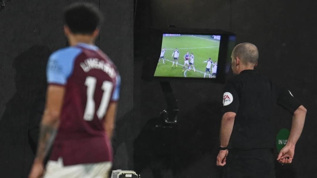 Referee Mike Dean checks the VAR monitor