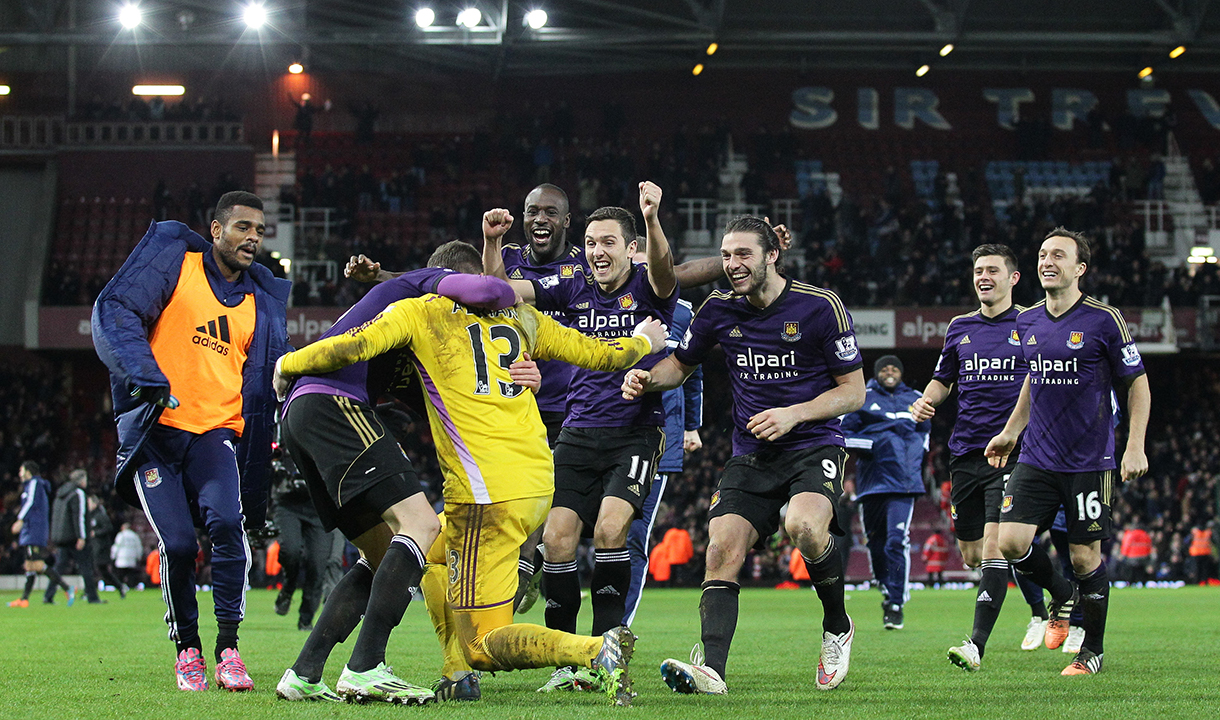 Adrián is mobbed after his winning penalty