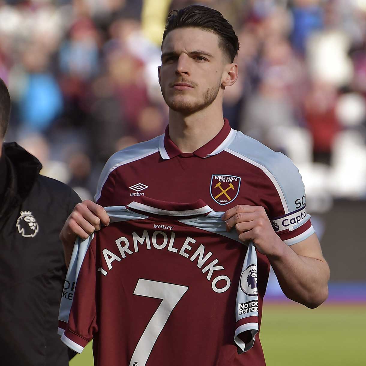 Declan Rice holds up Andriy Yarmolenko's shirt