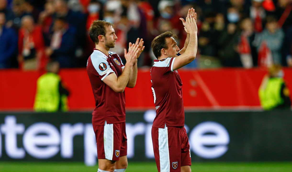 Craig Dawson and Mark Noble applaud the fans in Seville