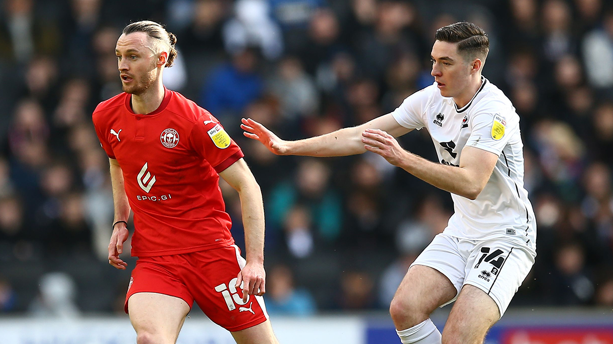 Conor Coventry (right) playing for MK Dons at Wigan