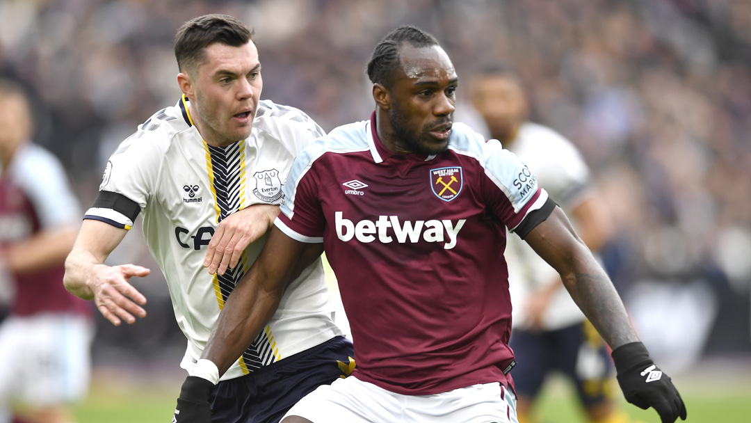 Michail Antonio holds off Michael Keane