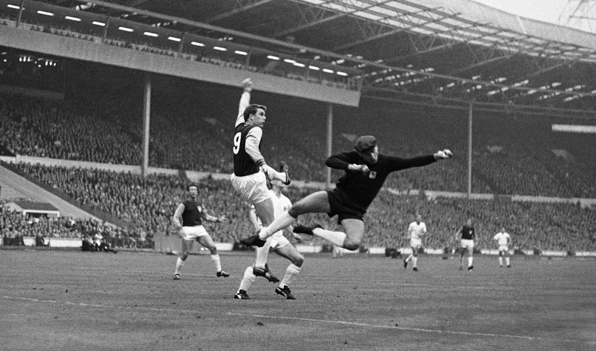 Sir Geoff challenges TSV 1860 Munich goalkeeper Peter Radenkovic in the 1965 European Cup Winners' Cup final