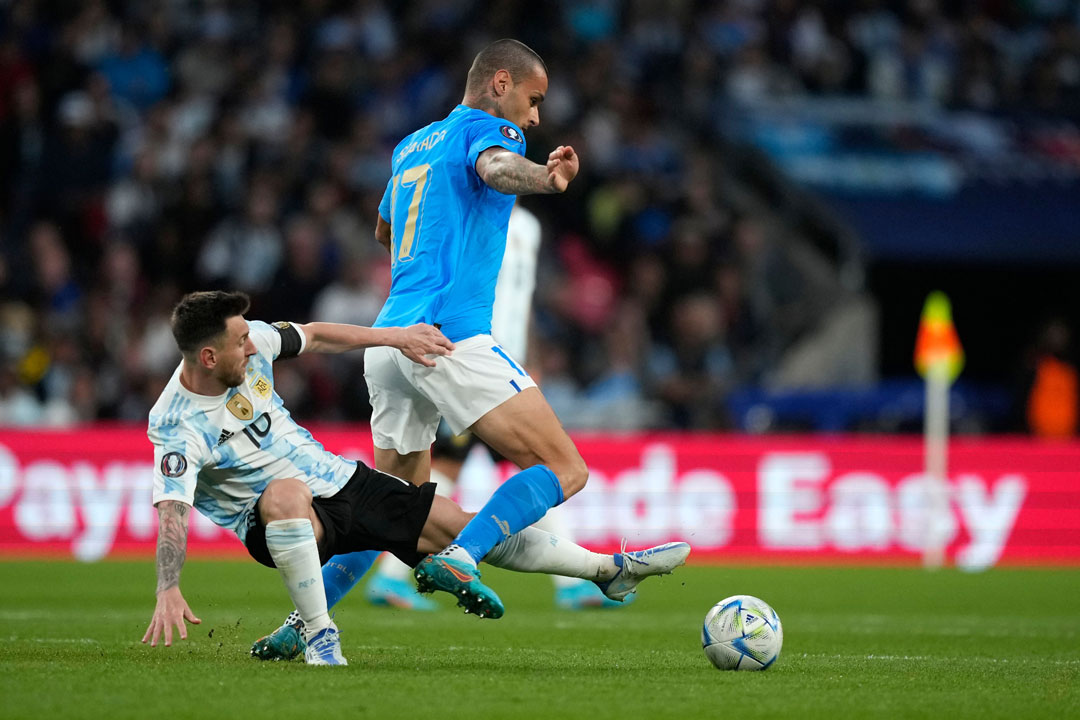 Gianluca Scamacca holds off Lionel Messi