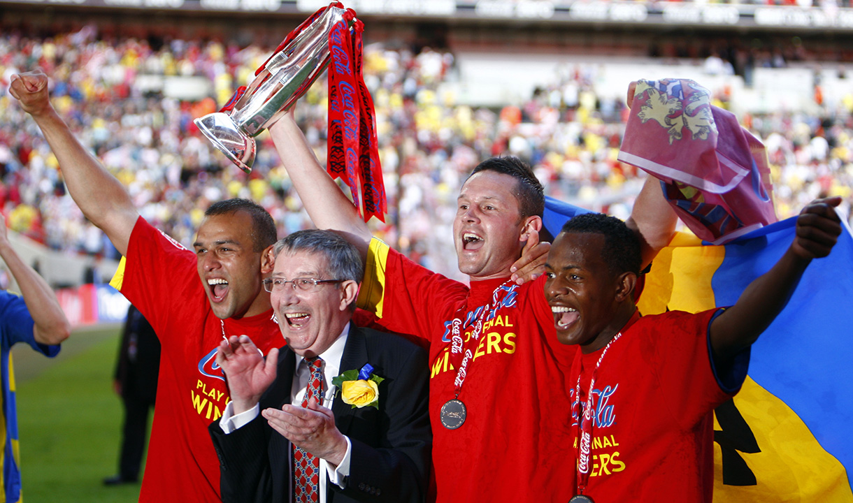 Anwar Uddin lifts the EFL League Two play-off trophy for Dagenham & Redbridge