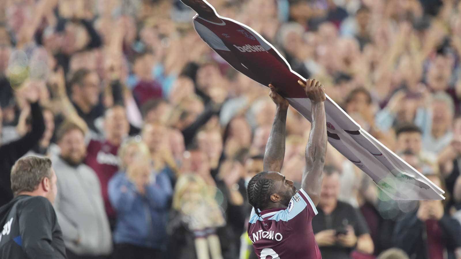 Michail Antonio celebrates beating the Club's Premier League goalscoring record by holding a cardboard cutout of himself aloft