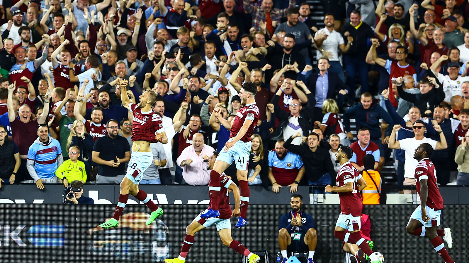 West Ham players celebrate with the crowd after equalising against Spurs