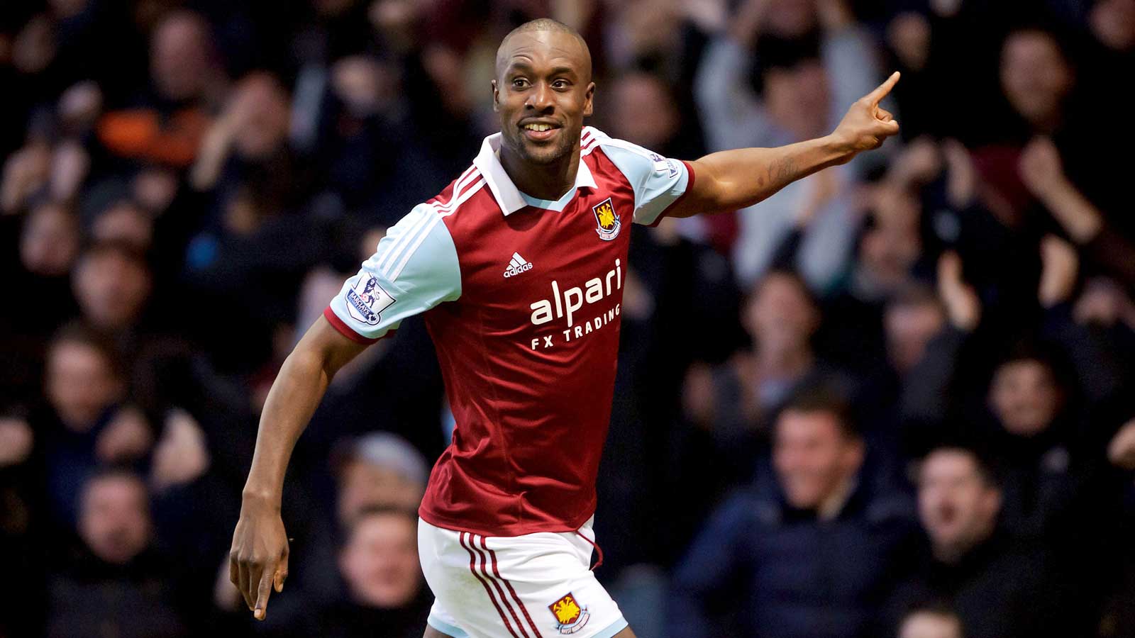 Carlton Cole celebrates scoring a goal for West Ham United