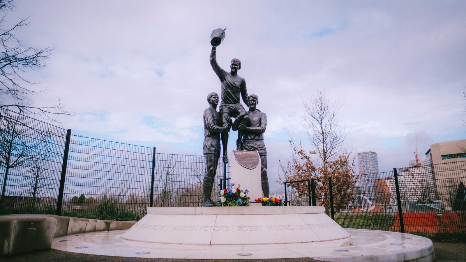 Flowers at the statue of Bobby Moore, Geoff Hurst and Martin Peters