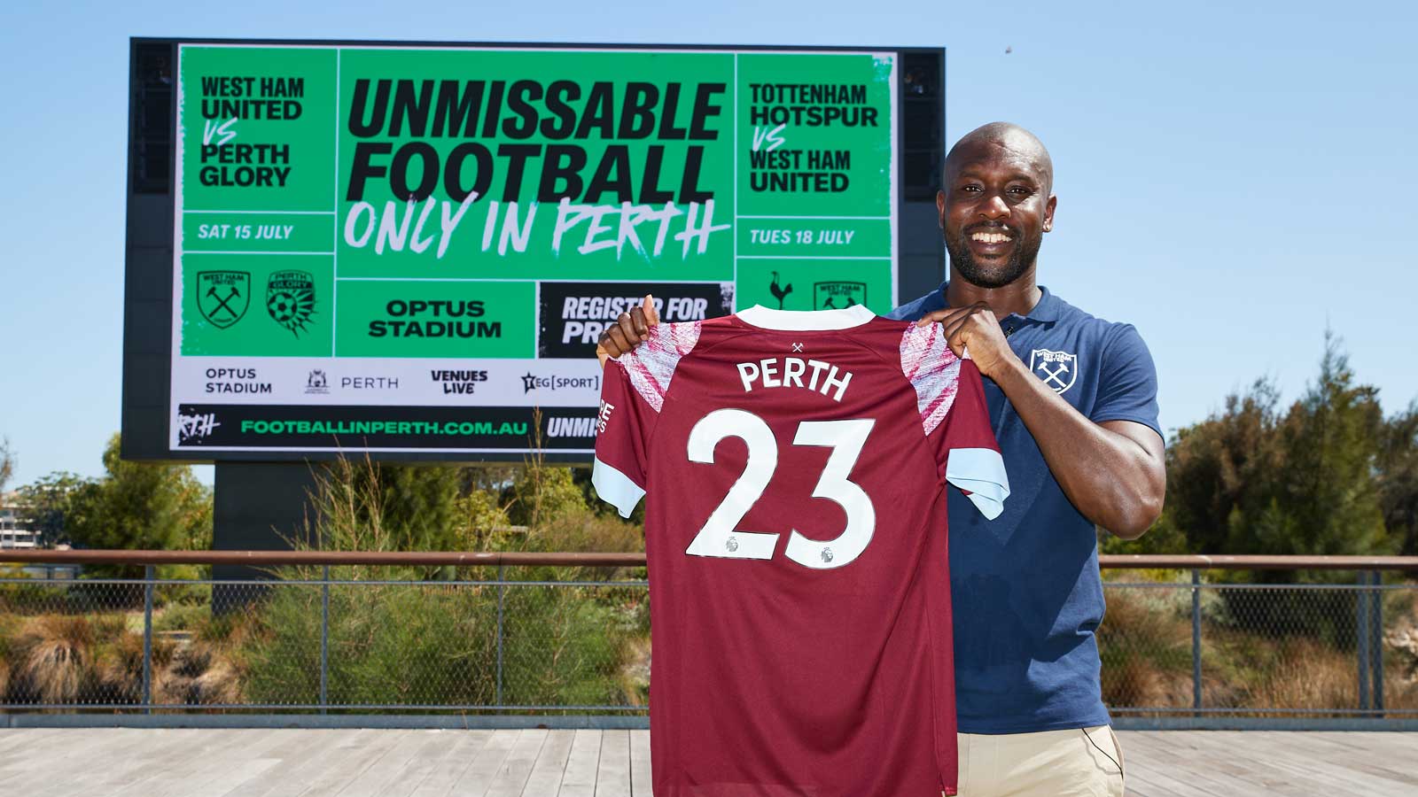 Carlton Cole holds up a West Ham shirt in Perth
