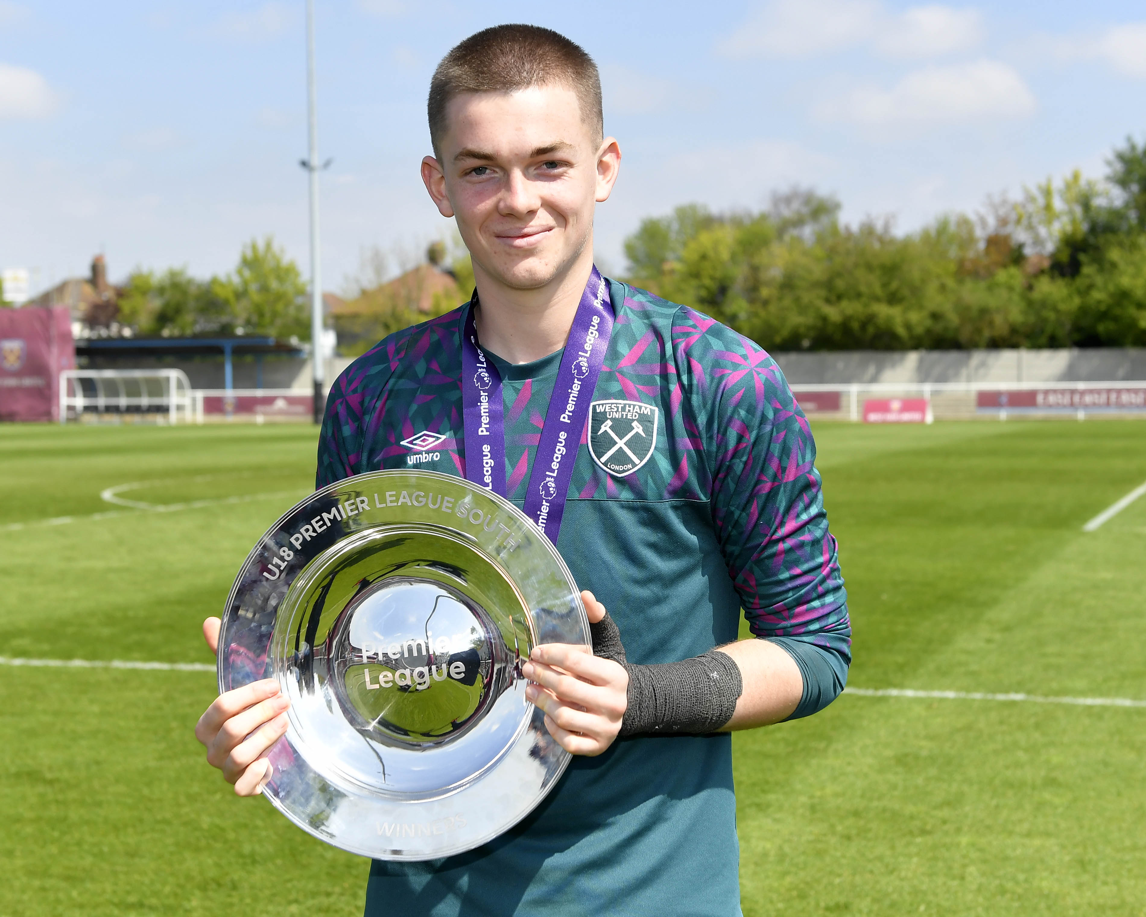 Finlay Herrick holding the U18s Premier League South trophy