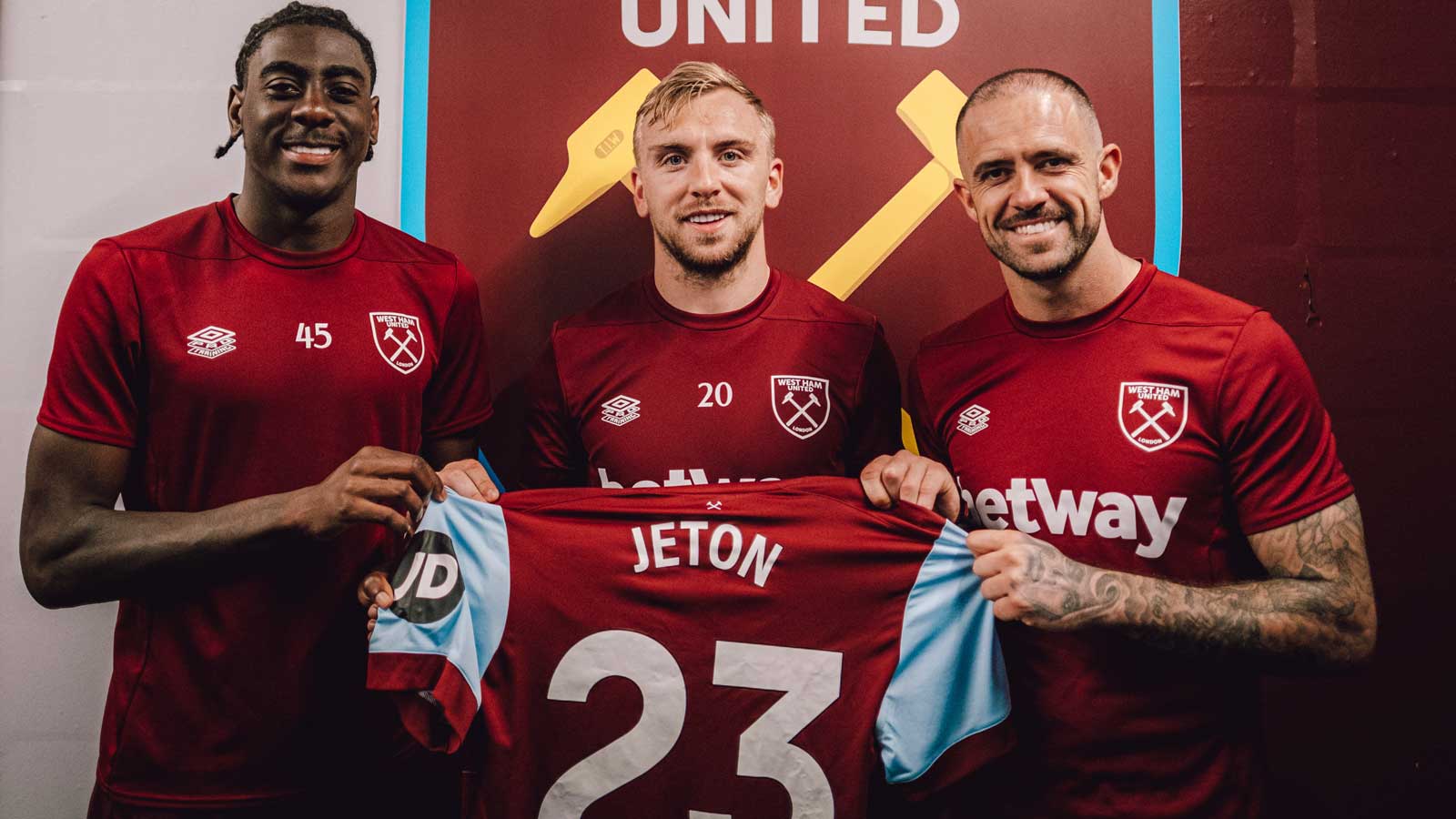 Divin Mubama, Jarrod Bowen and Danny Ings hold a West Ham United shirt with 'Jeton 23' printed on the back