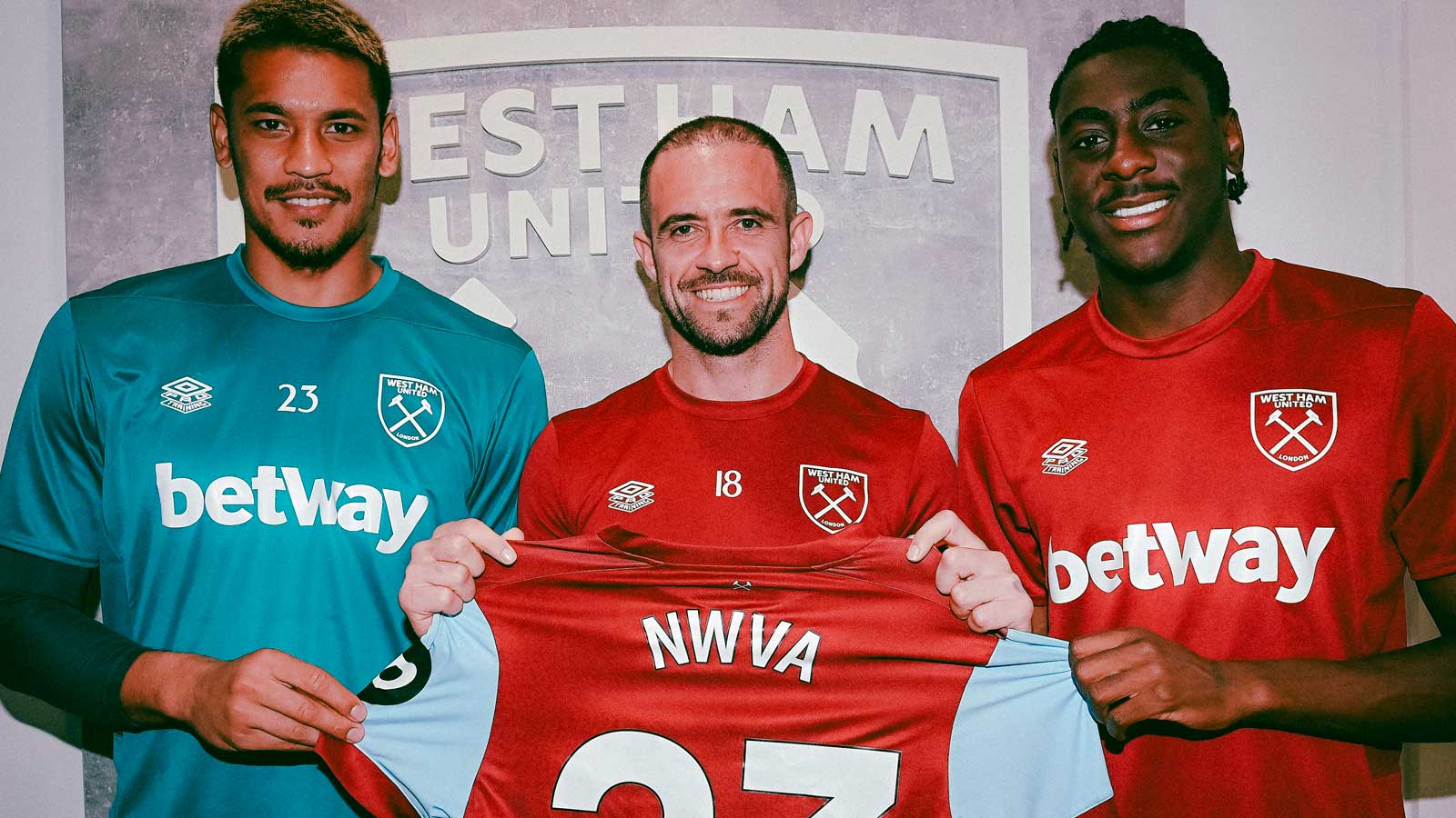 Alphonse Areola, Danny Ings and Divin Mubama hold a shirt with NWVA on the back