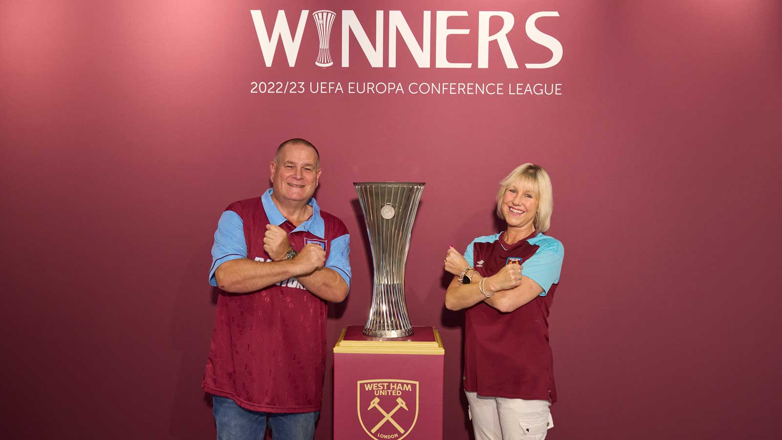 West Ham United supporters pose with the UEFA Europa Conference League trophy