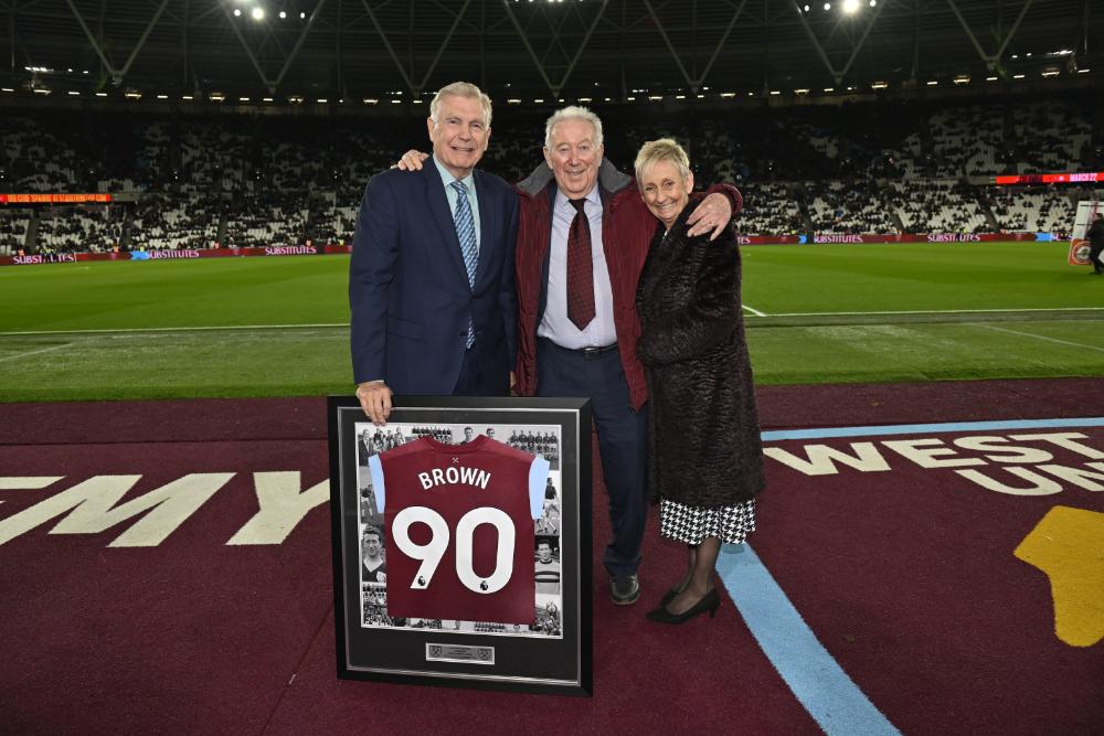 Ken Brown with his wife Elaine and Sir Trevor Brooking at London Stadium