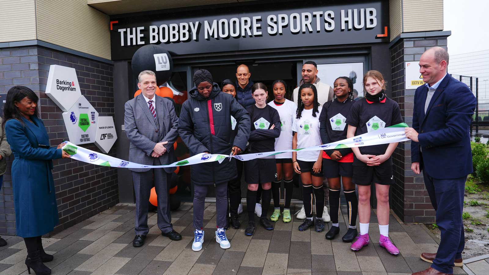 Hawa Cissoko cuts the ribbon to open the Bobby Moore Sports Hub
