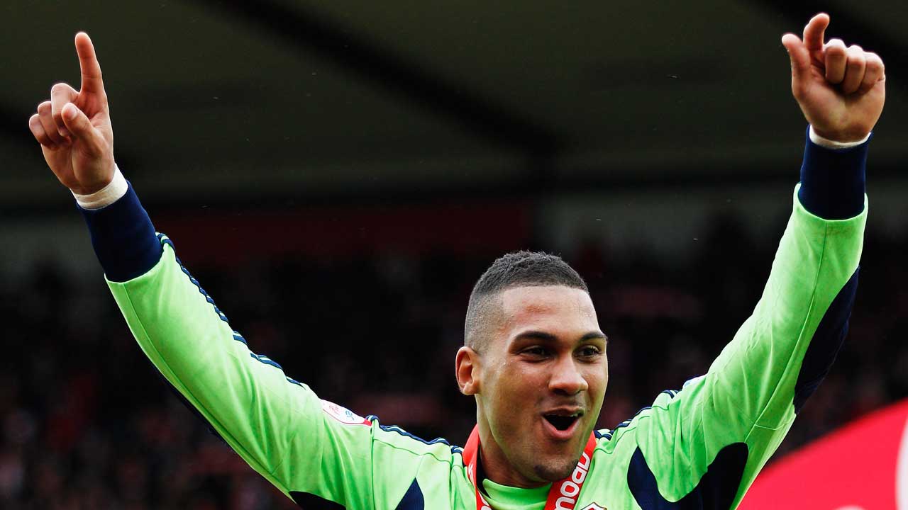 Wes Foderingham celebrates winning League Two with Swindon Town in 2012
