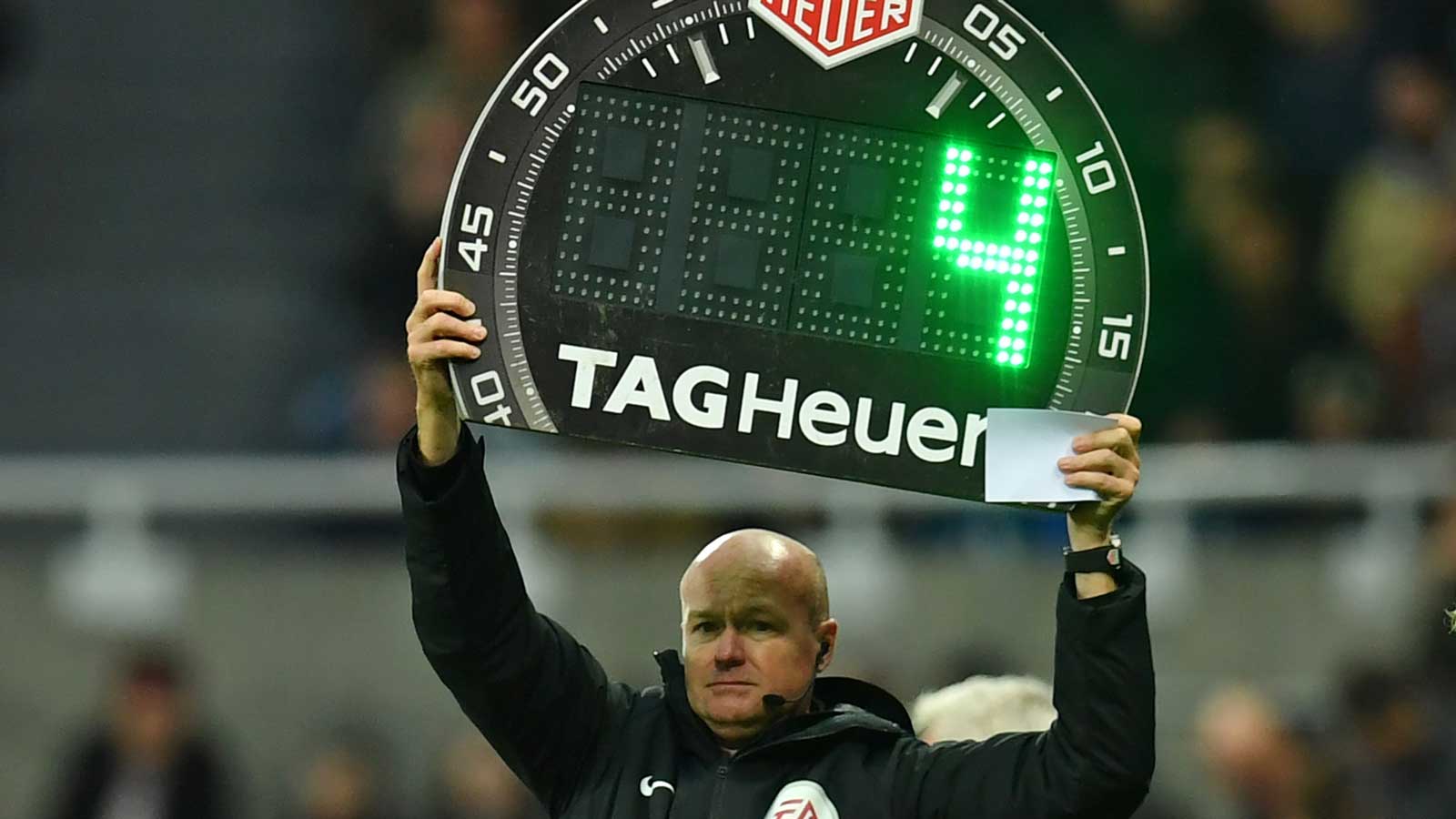 A fourth official holds up a board for added time