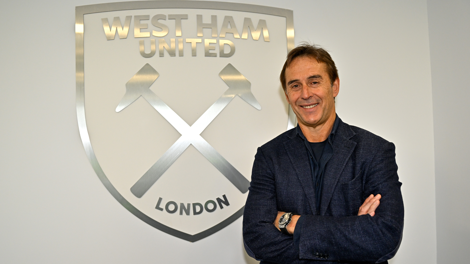 Julen Lopetegui poses in front of a West Ham United crest