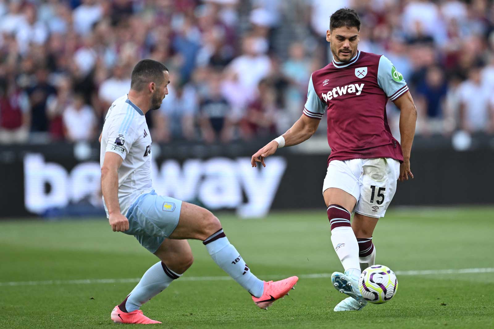 Dinos Mavropanos passes the ball against Aston Villa